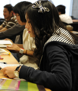 Student working at table in classroom.