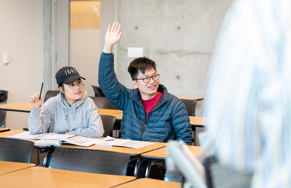 Student raising his hand in class