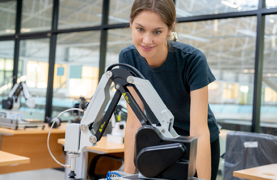 Woman looking at robotic arm