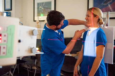 Rad Tech instructor pointing at x-rays to students in class