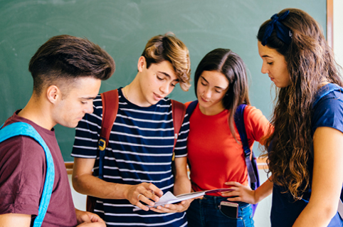 Students looking at a notebook together