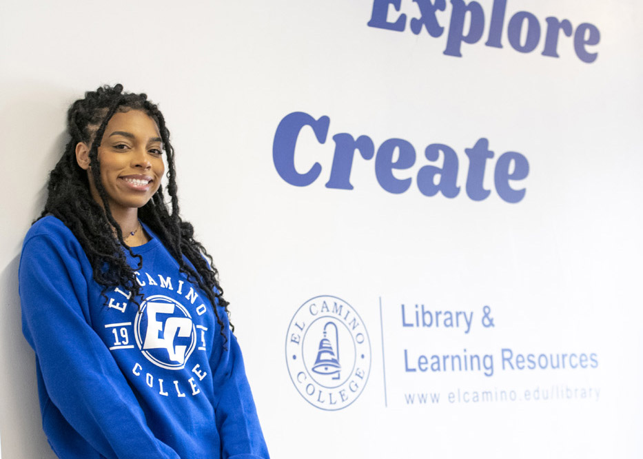 Student leaning against the wall in the Library Lobby