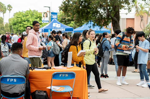 Students walking around a university fair on campus