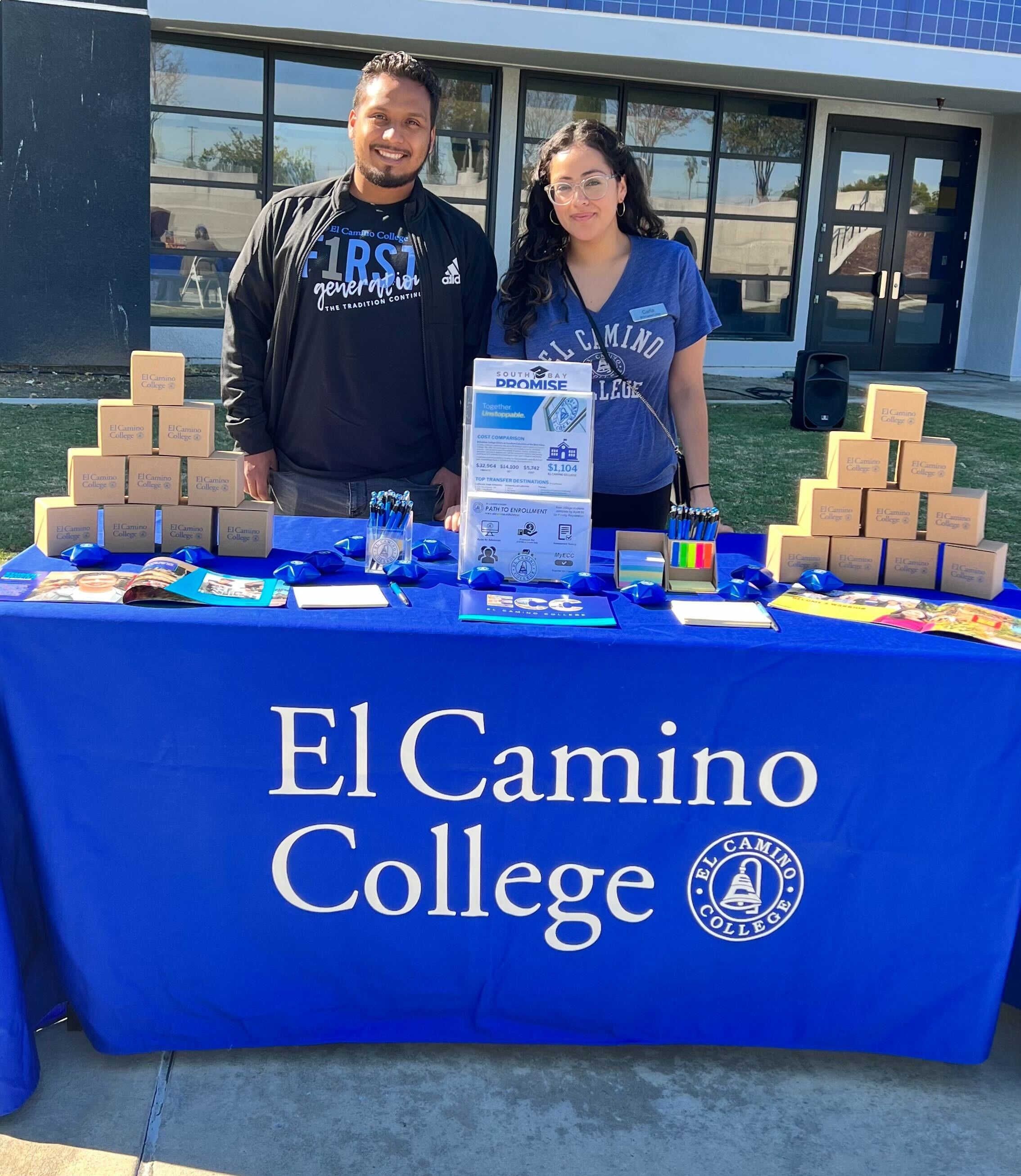 Outreach Staff Tabling at a Fair Off-Campus