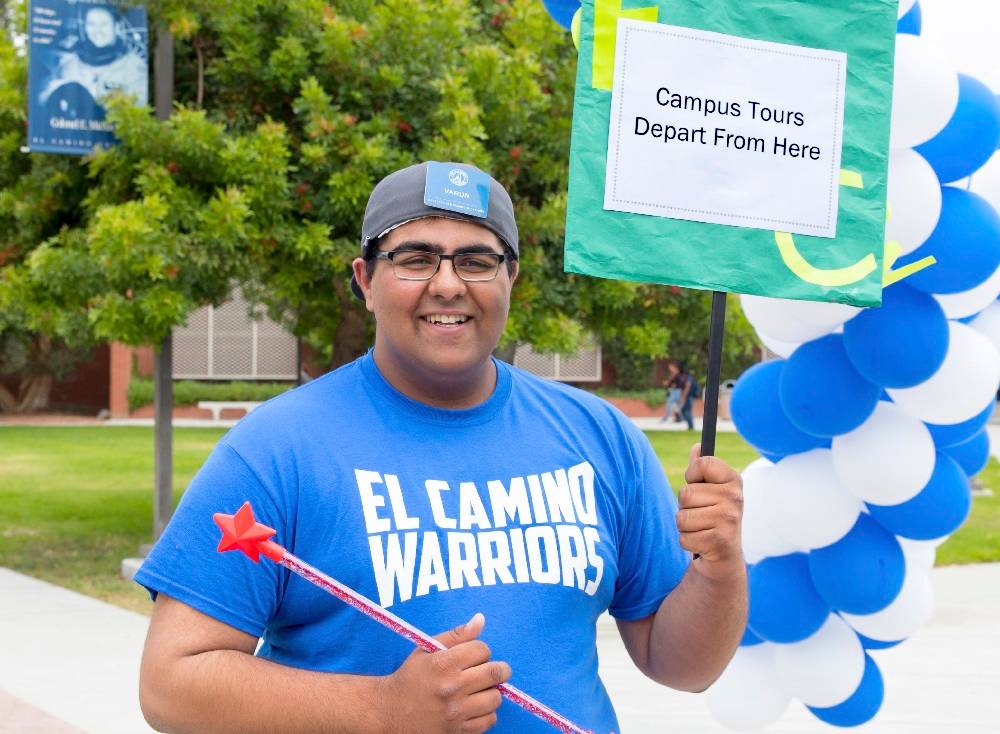 Ambassador with Campus Tour Sign