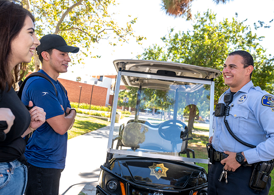 Police officer talking to students