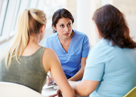 Nurse talking to two people