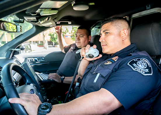 Police officer using radio in car 