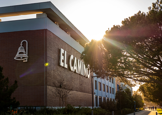 El Camino sign on building during sunset.