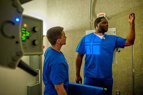 Students practicing with an imaging machine in class