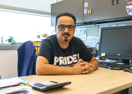 Rene Lozano sits at his office desk.