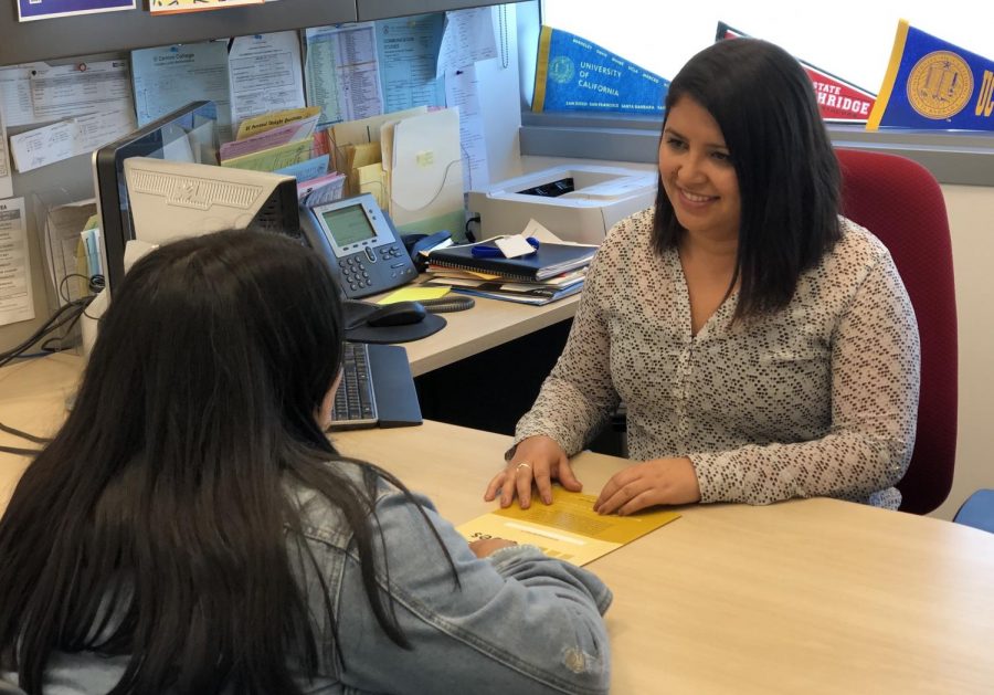 Counselor and student talking at desk