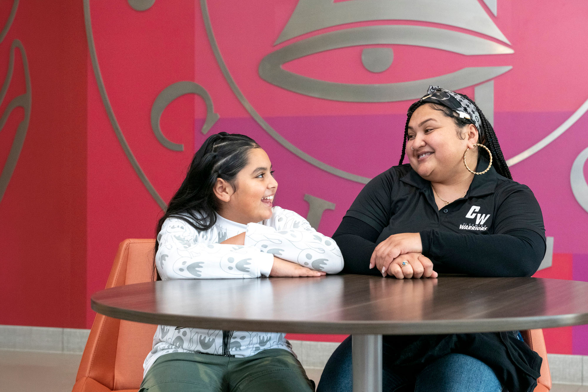 Mom and daughter sitting at table
